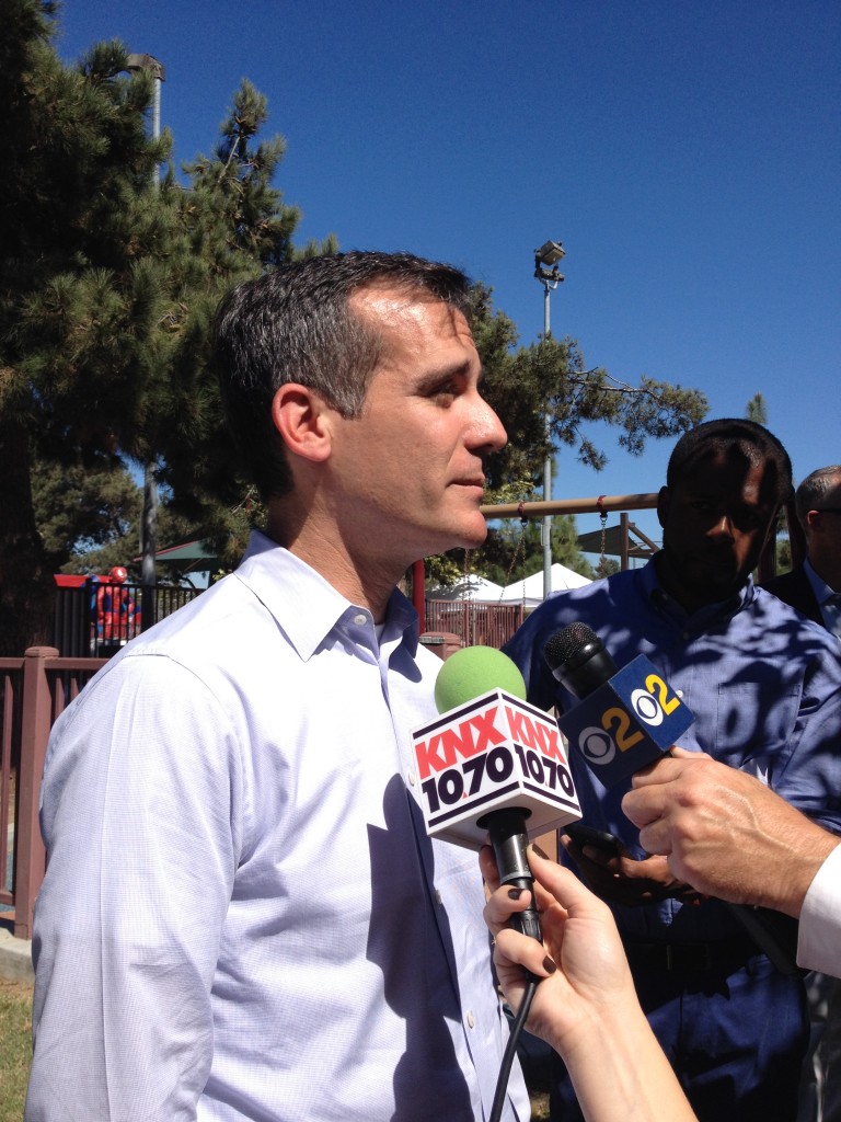 Los Angeles Mayor Eric Garcetti speaks to journalists at Powerfest South LA. Garcetti said he wants Los Angeles to register more people for health care than anywhere else in the US. Photo by Katherine Davis.