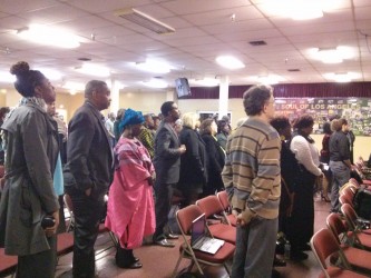 Community members observing a minute of silence remembering the late Marguerite Poindexter LaMotte at the First AME church| Photo credit: Sinduja Rangarajan