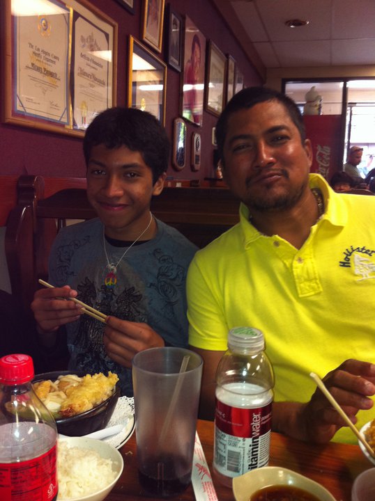A younger Miguel with his father at a restaurant in Los Angeles. 