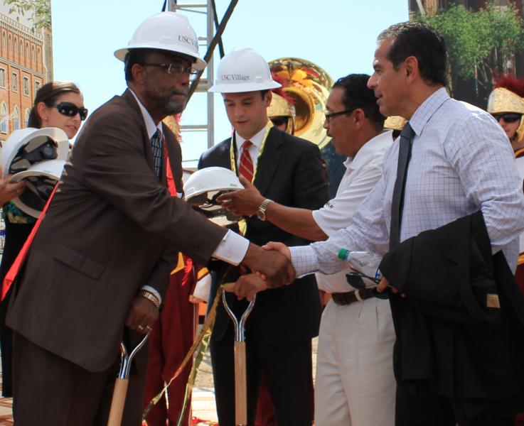 L.A. District 9 councilman Curren Price greets former mayor Antonio Villaraigosa after the groundbreaking. | Phoenix Tso/Neon Tommy 