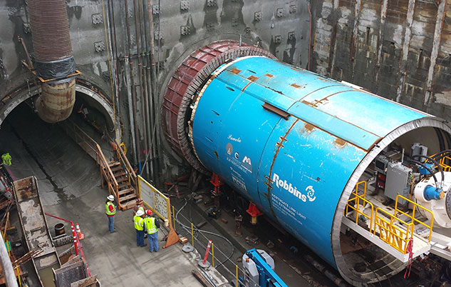 A soon-to-be-named tunnel boring machine (TBM) similar to Seattle's Pamela, pictured in blue, will carve out the Crenshaw/LAX line's twin tunnels.