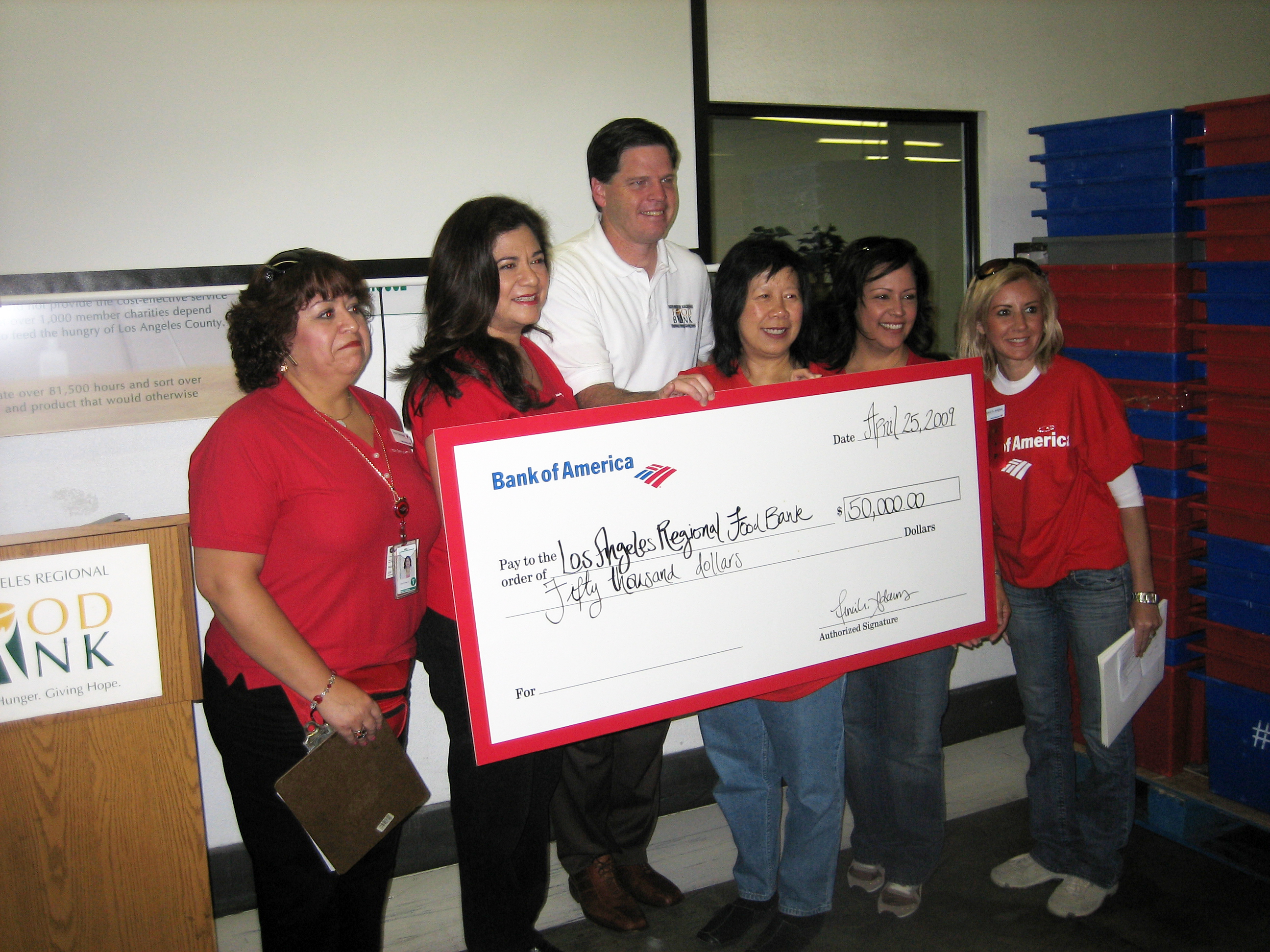 L.A. Regional Foodbank President and CEO Michael Flood receives a check for $50,000 from Bank of America.