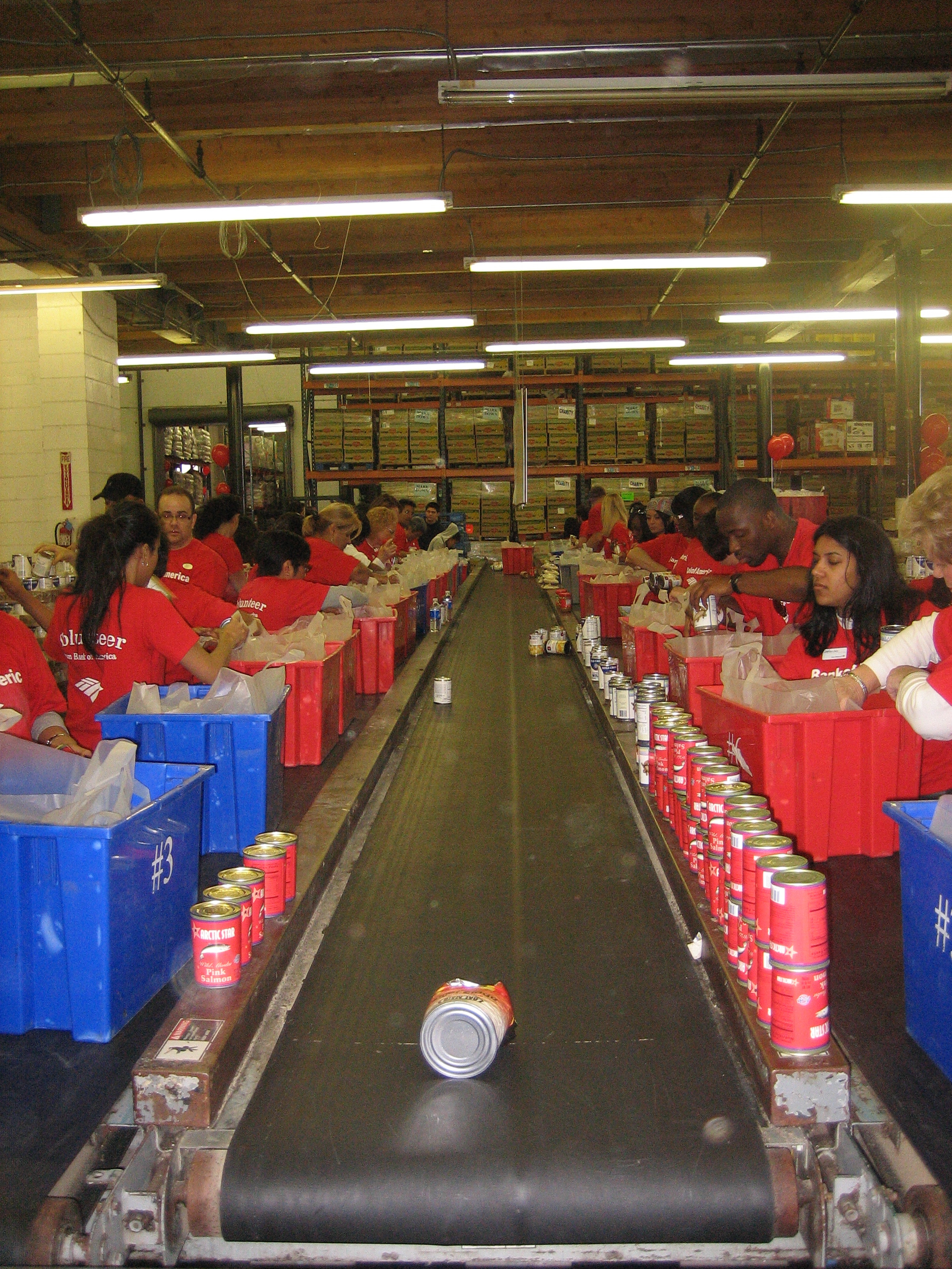 Bank of America employees assemble bags of food for low-income seniors.