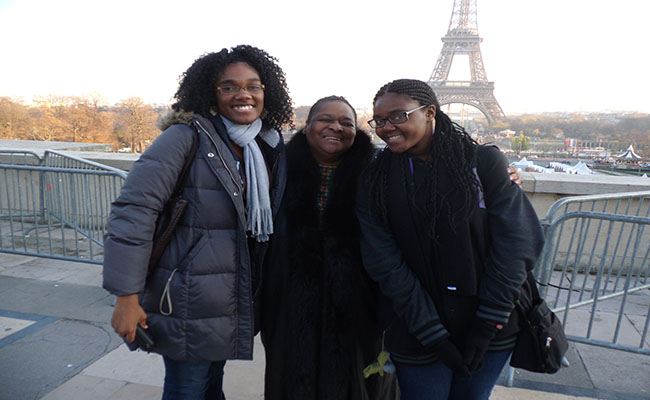 Stevenson, Leah Scurlock and I take a photo with the Eiffel Tower in the distance during the Crenshaw Choir's trip to France and Washington DC in December 2013. | Amanda Scurlock