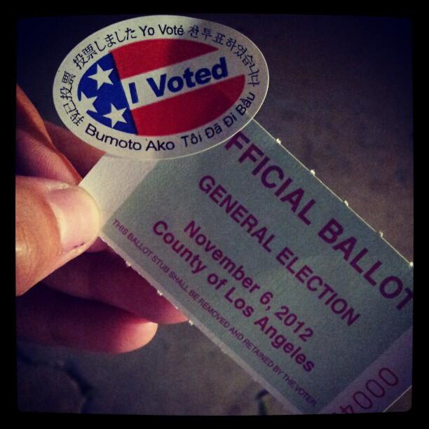 A voter in South L.A. shows off her ballot stub. | 