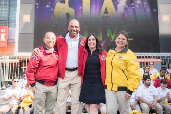 L.A. Clippers Coach Doc Rivers and L.A. Clippers President of Business Operations stands with  City Year AmeriCorps members.